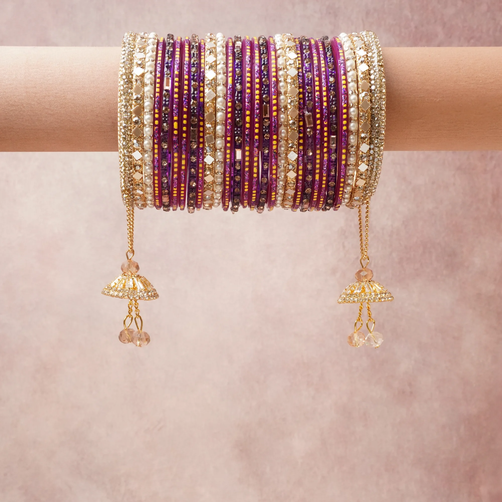 A grounding Deep Royal Purple forms the heart of the set, while touches of Gold, Cream, Bright Yellow, Rose Gold, Clear, Peach add charm.

A thoughtful composition of Glass, Gold-toned Metal, Pearls, Crystals, Mirrors, Enamel, designed to feel complete without being heavy.
Each element layers seamlessly, creating a look that is refined, wearable and quietly striking.